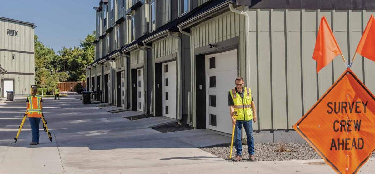 Survey crew locating along a row of garages